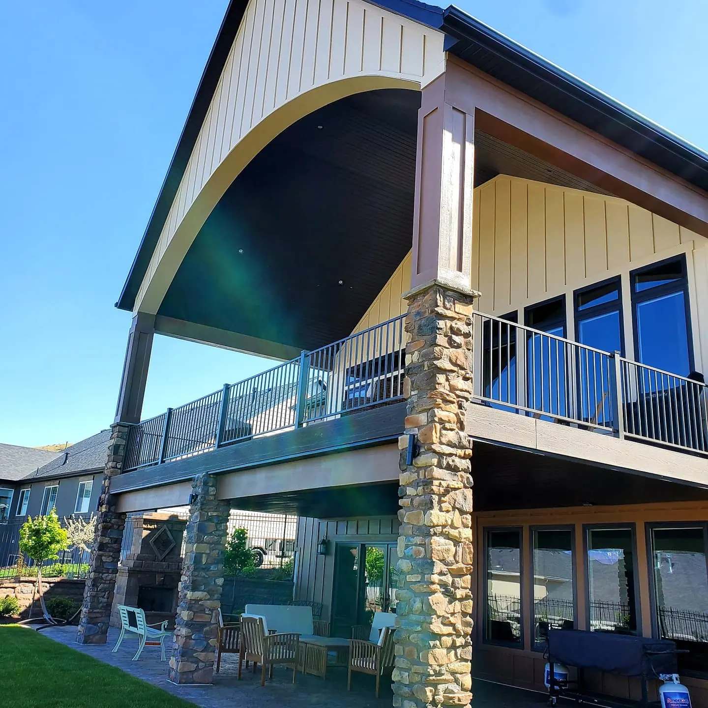 Covered deck with a vaulted gable roof and stone columns