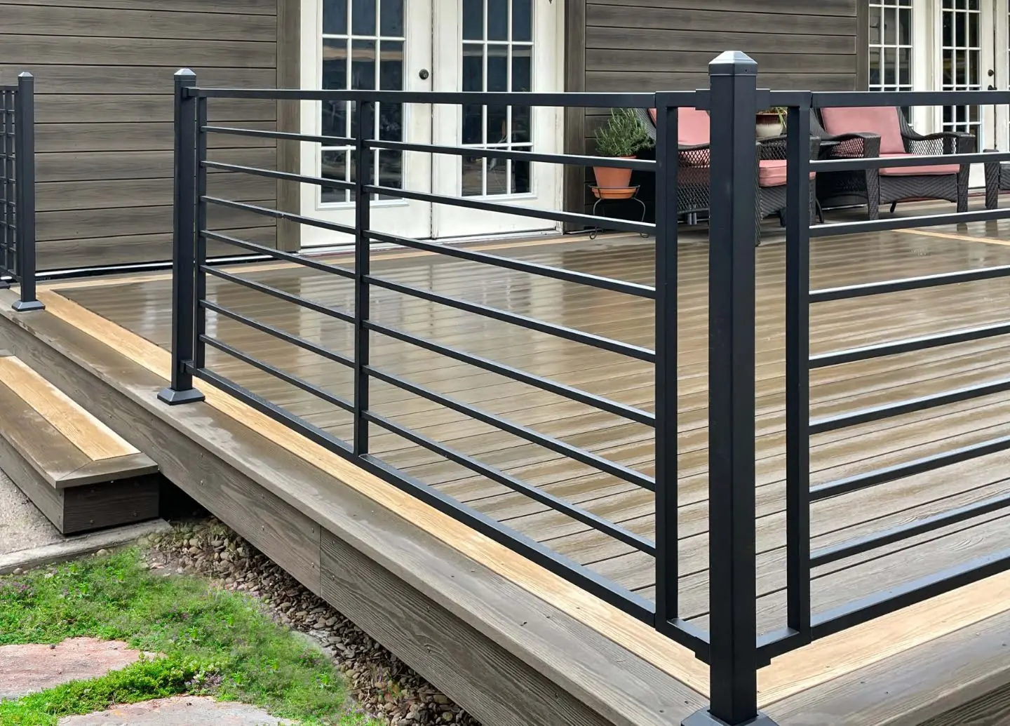 Horizontal rod railing on a composite deck with step lighting