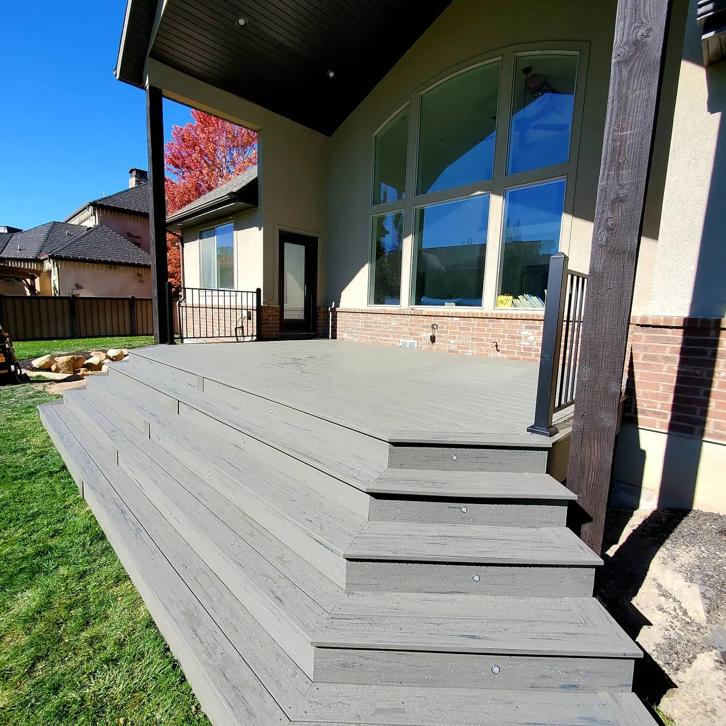 Wide cascading composite stairs off a covered deck