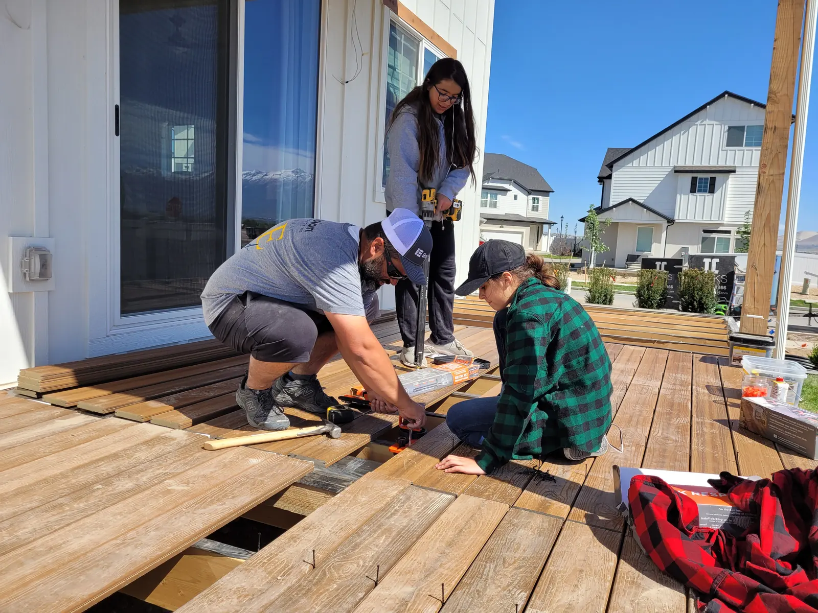 Women installing deck boards during The House that She Built