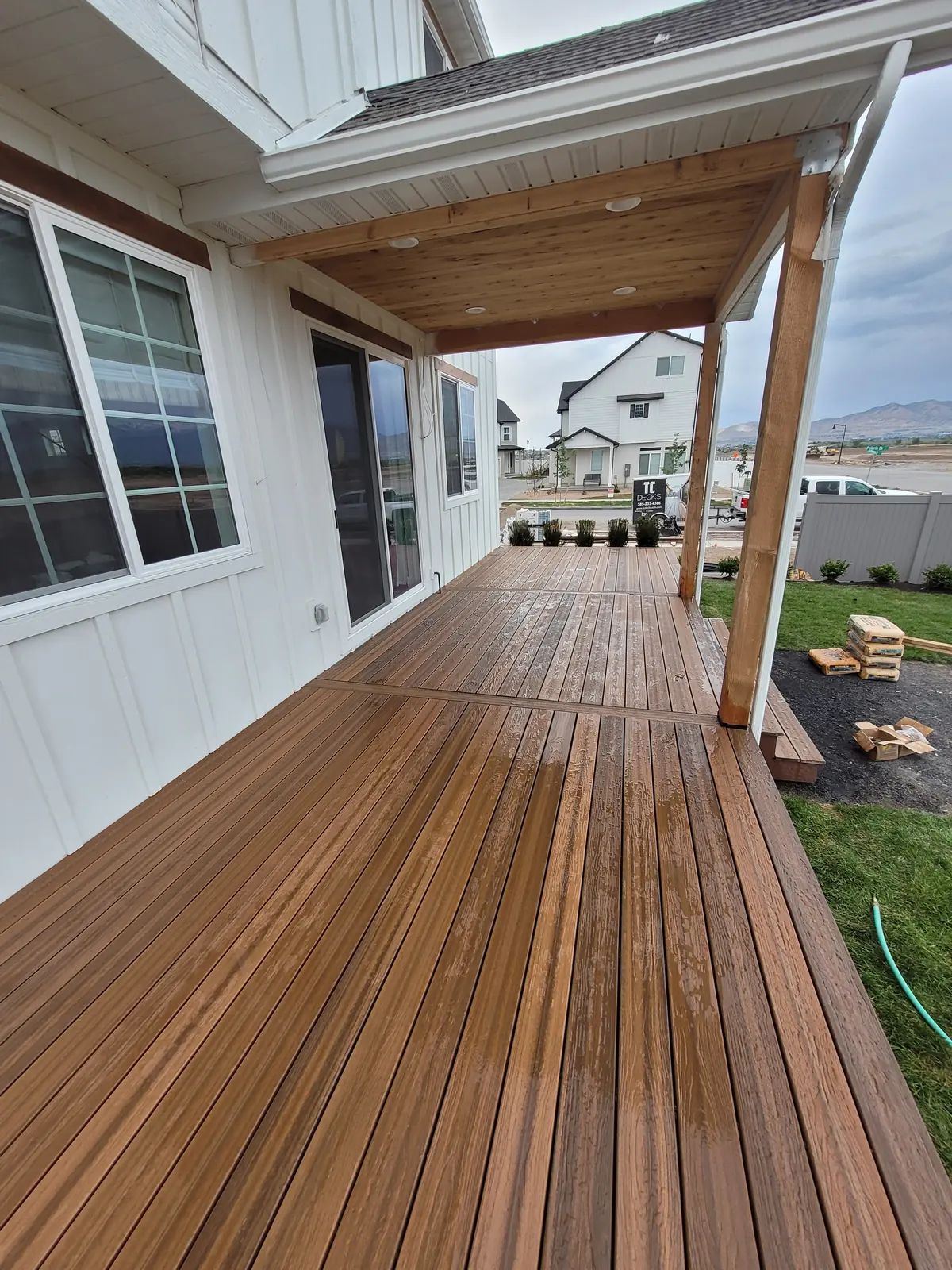 Long run of finished deck boards under a covered porch