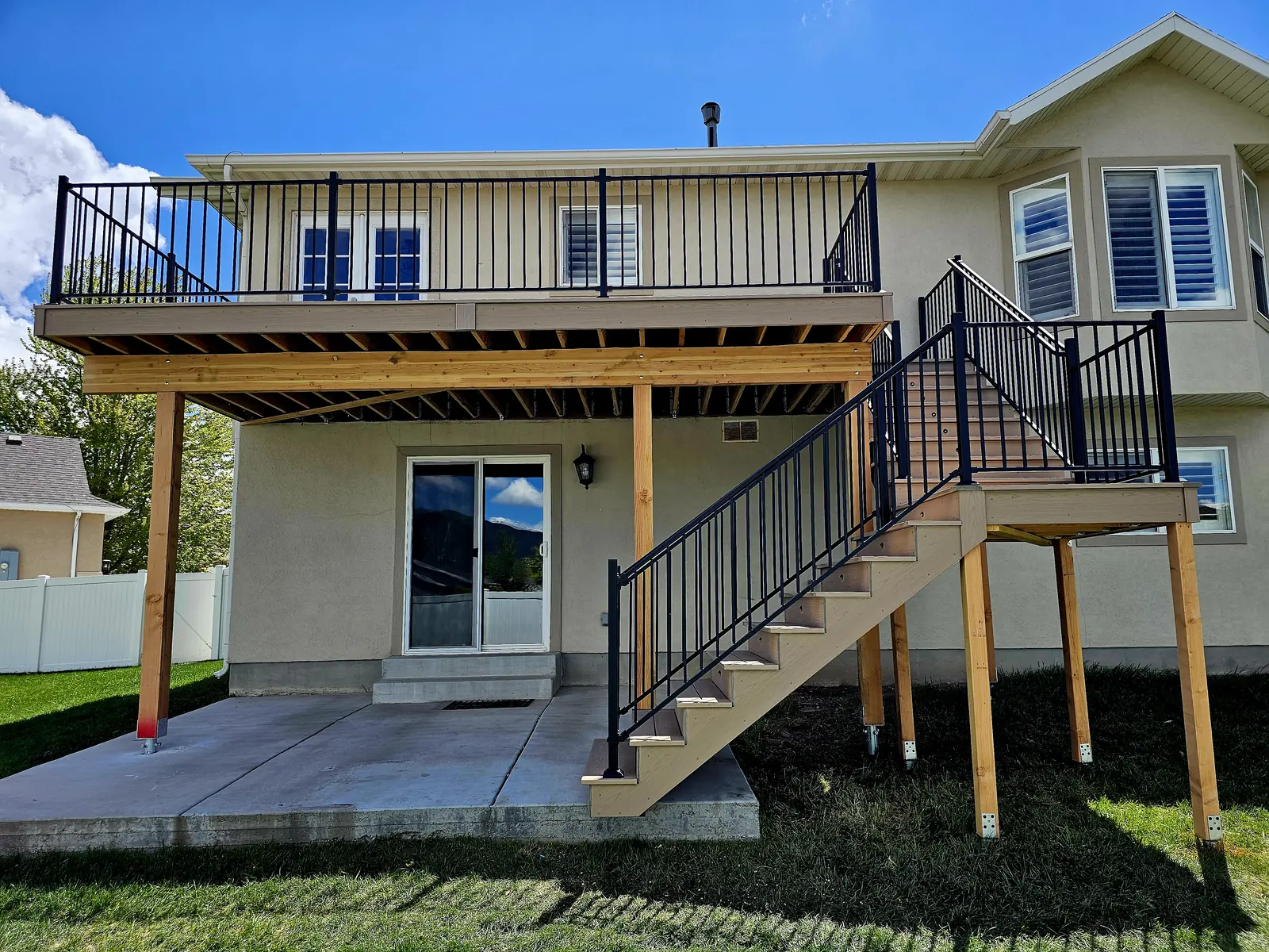 Second-story composite deck with black railing and stairs in American Fork, Utah