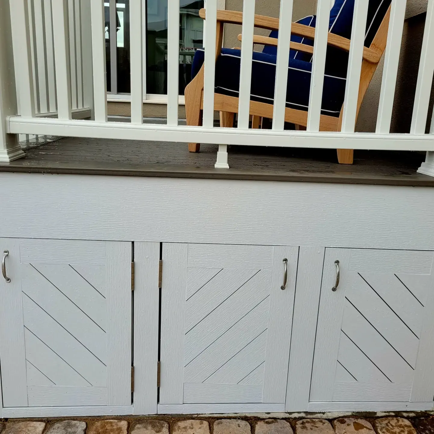 Under-deck storage cabinet doors with a diagonal board pattern
