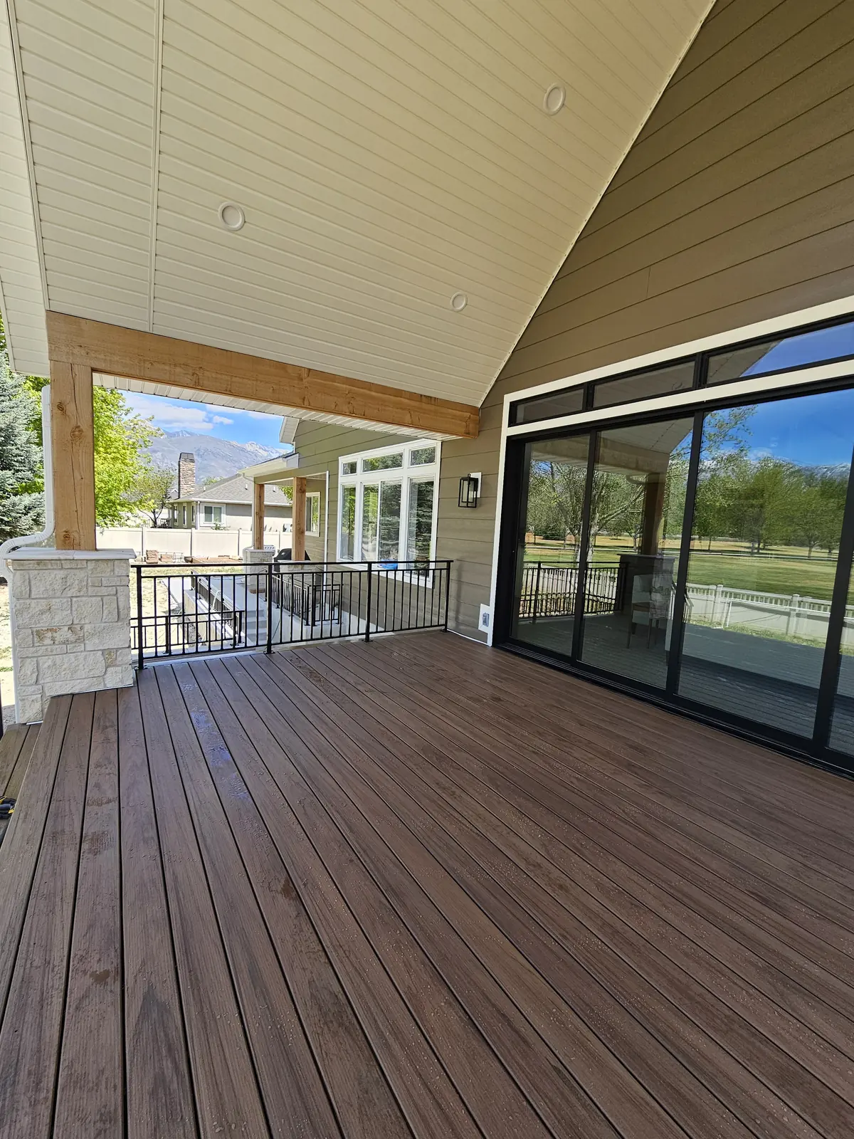 TimberTech Legacy Pecan deck with black railing and a view of the mountains