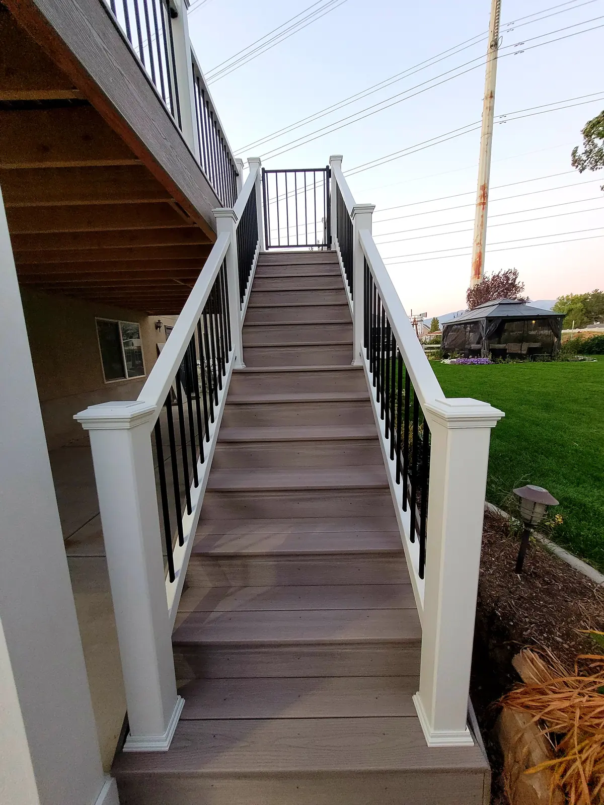 Long deck stairs with white railing