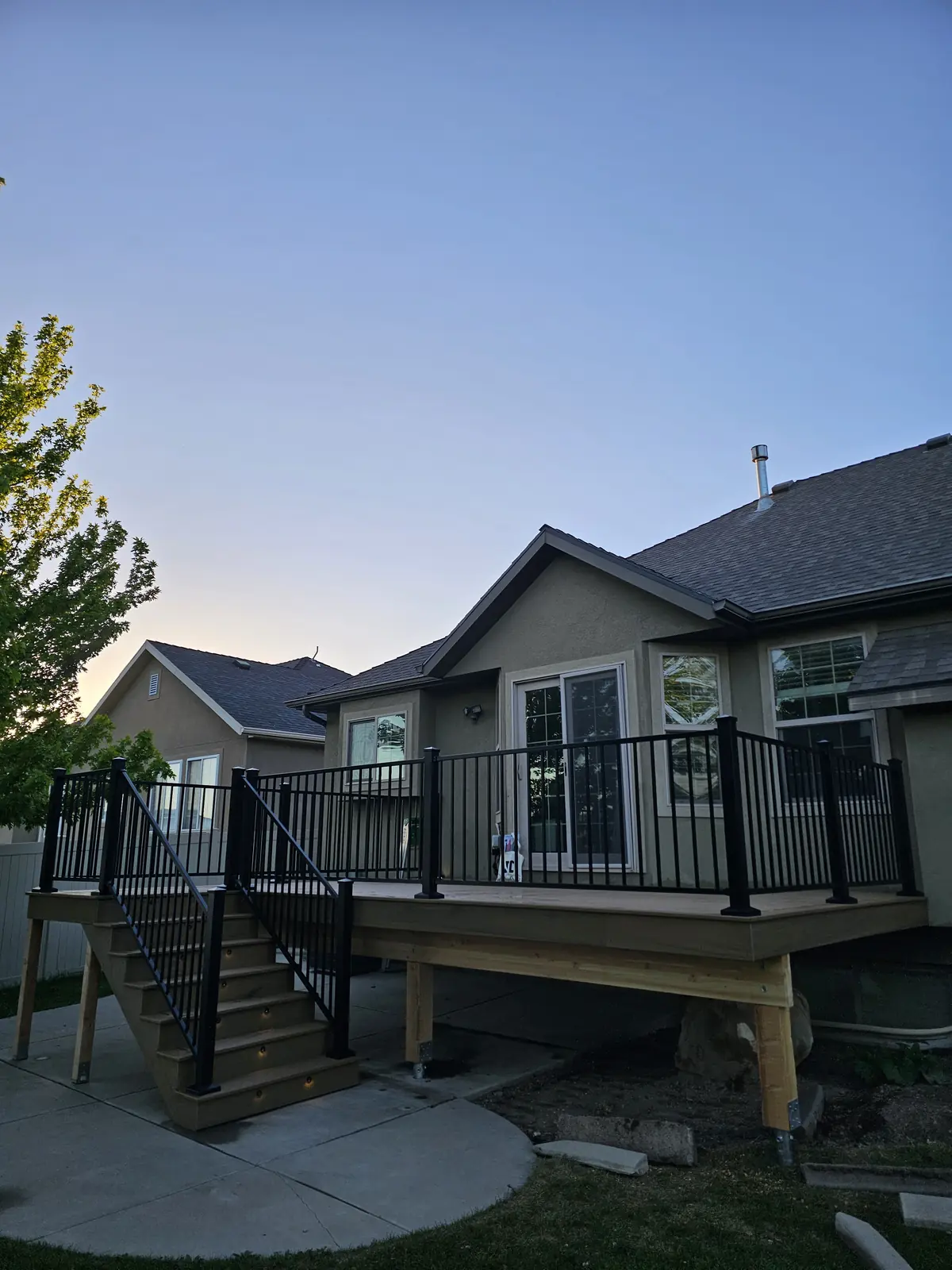 Raised deck with black railing at dusk