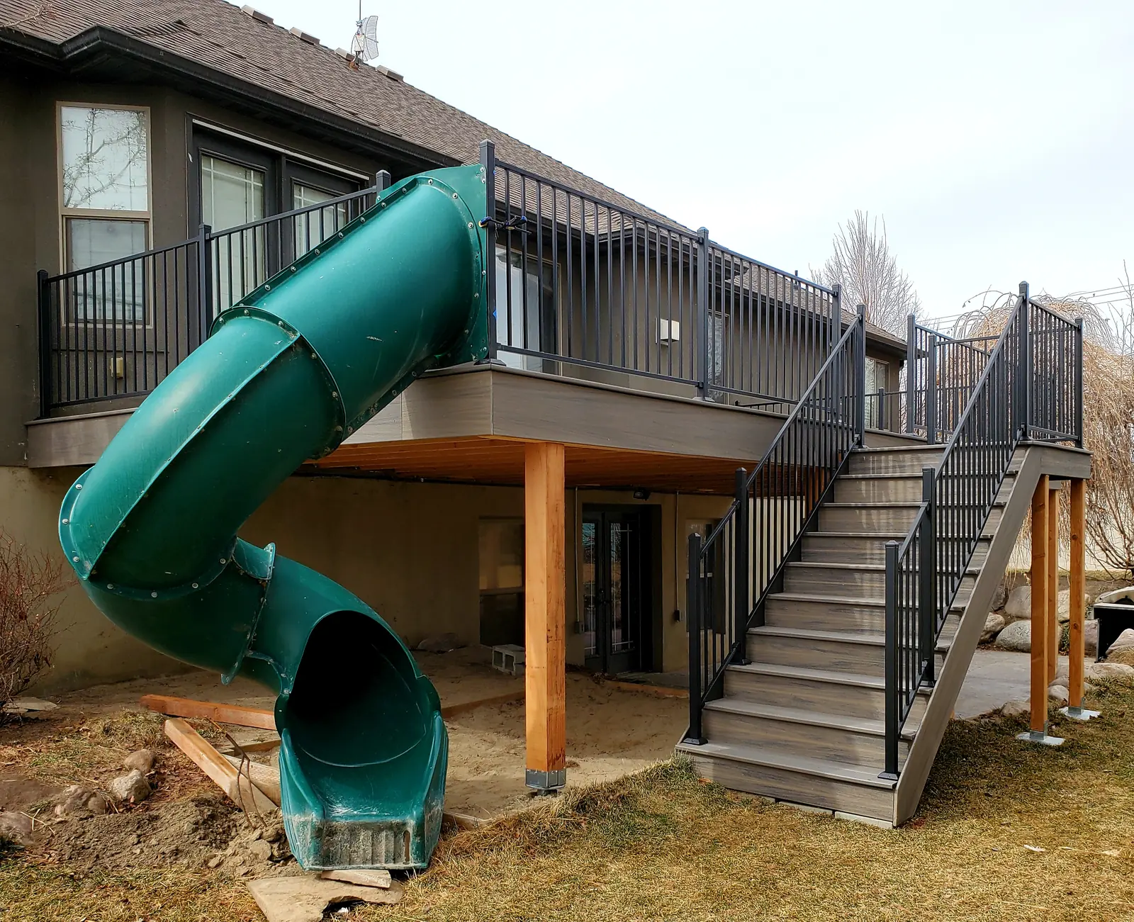 Second-story deck with a green tube slide