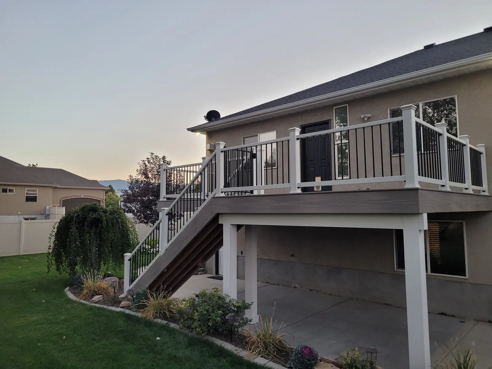 Second-story deck with white railing and stairs