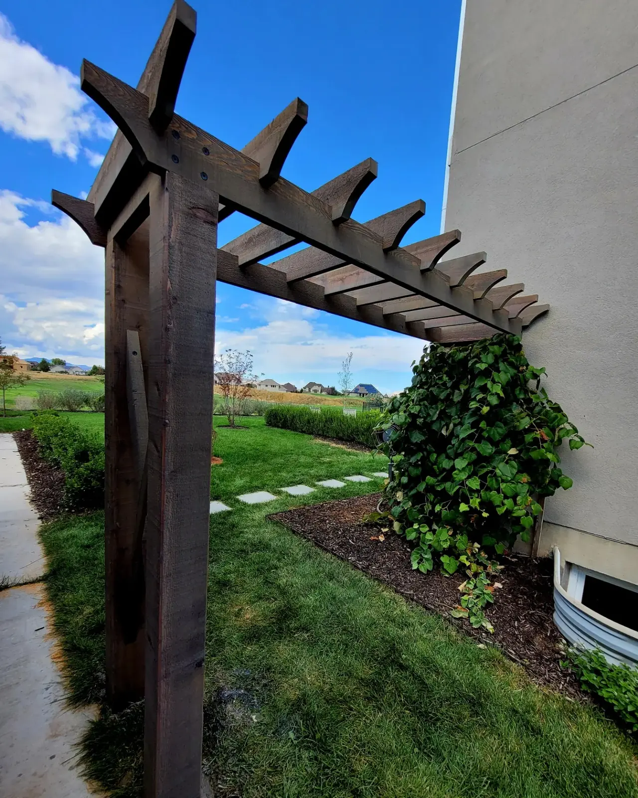 Rustic stained wood pergola arbor built by TC Decks