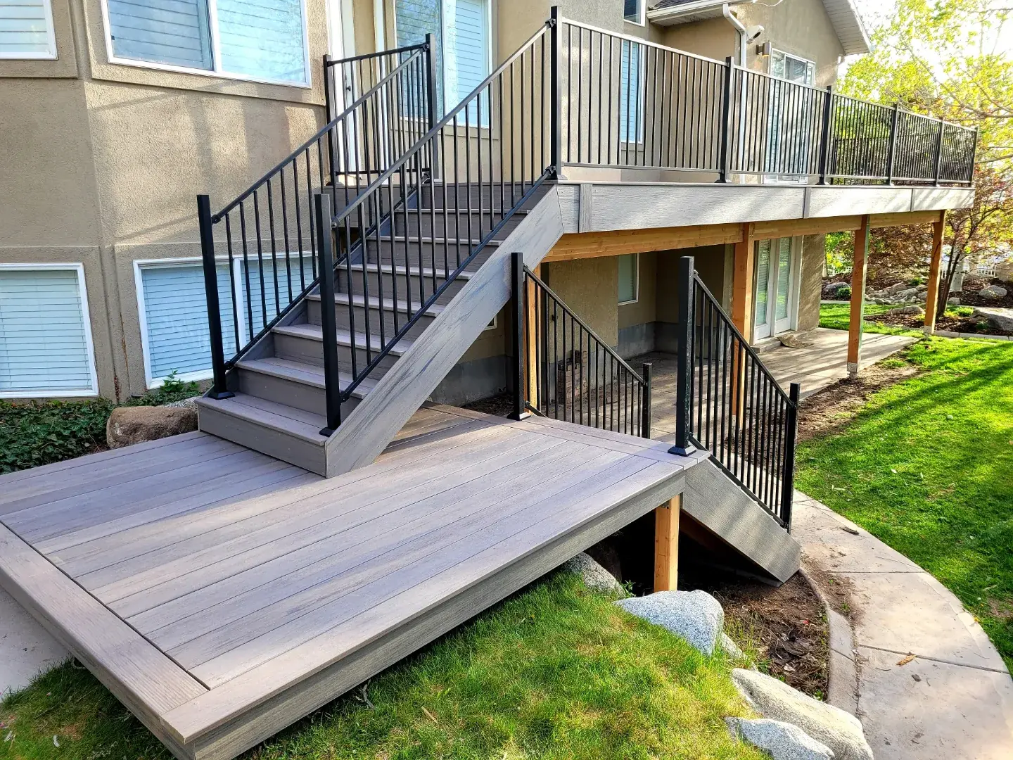 Upper deck with stairs down to a lower composite platform and black railing