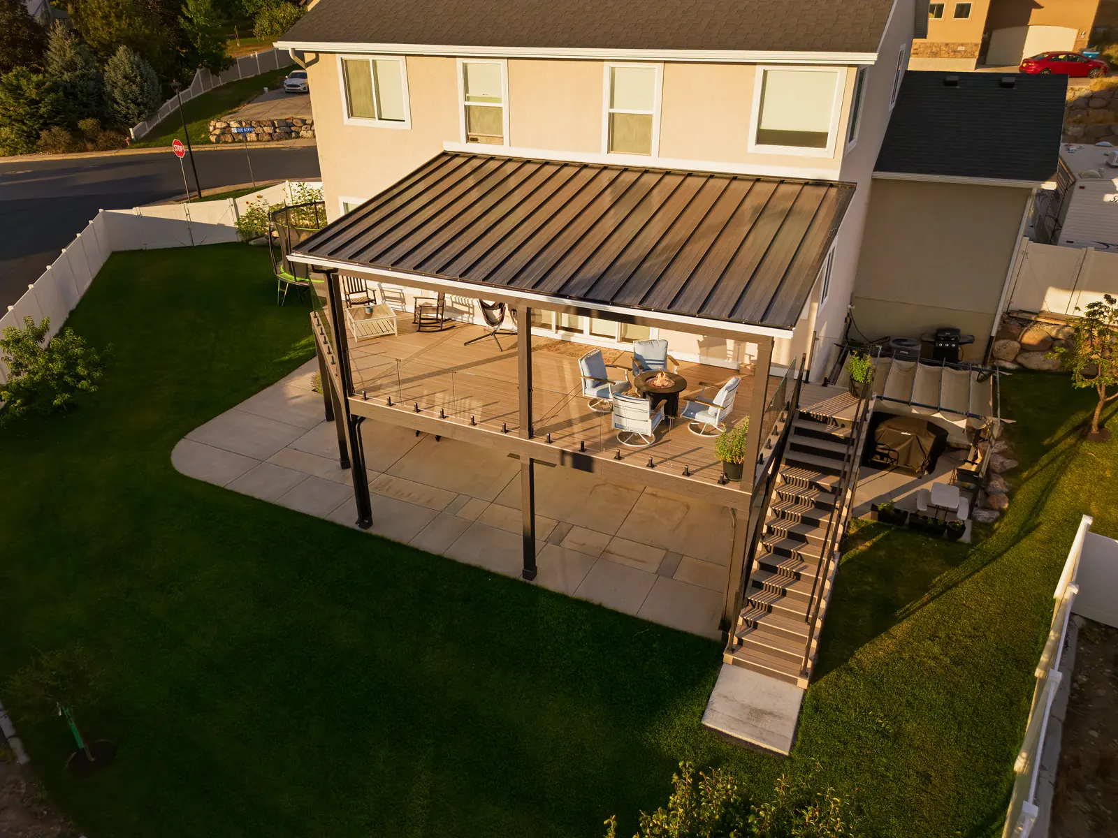 Aerial view of a covered deck, stairs and patio