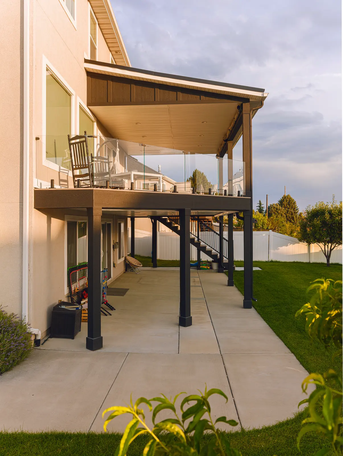 Covered second-story deck over a concrete patio