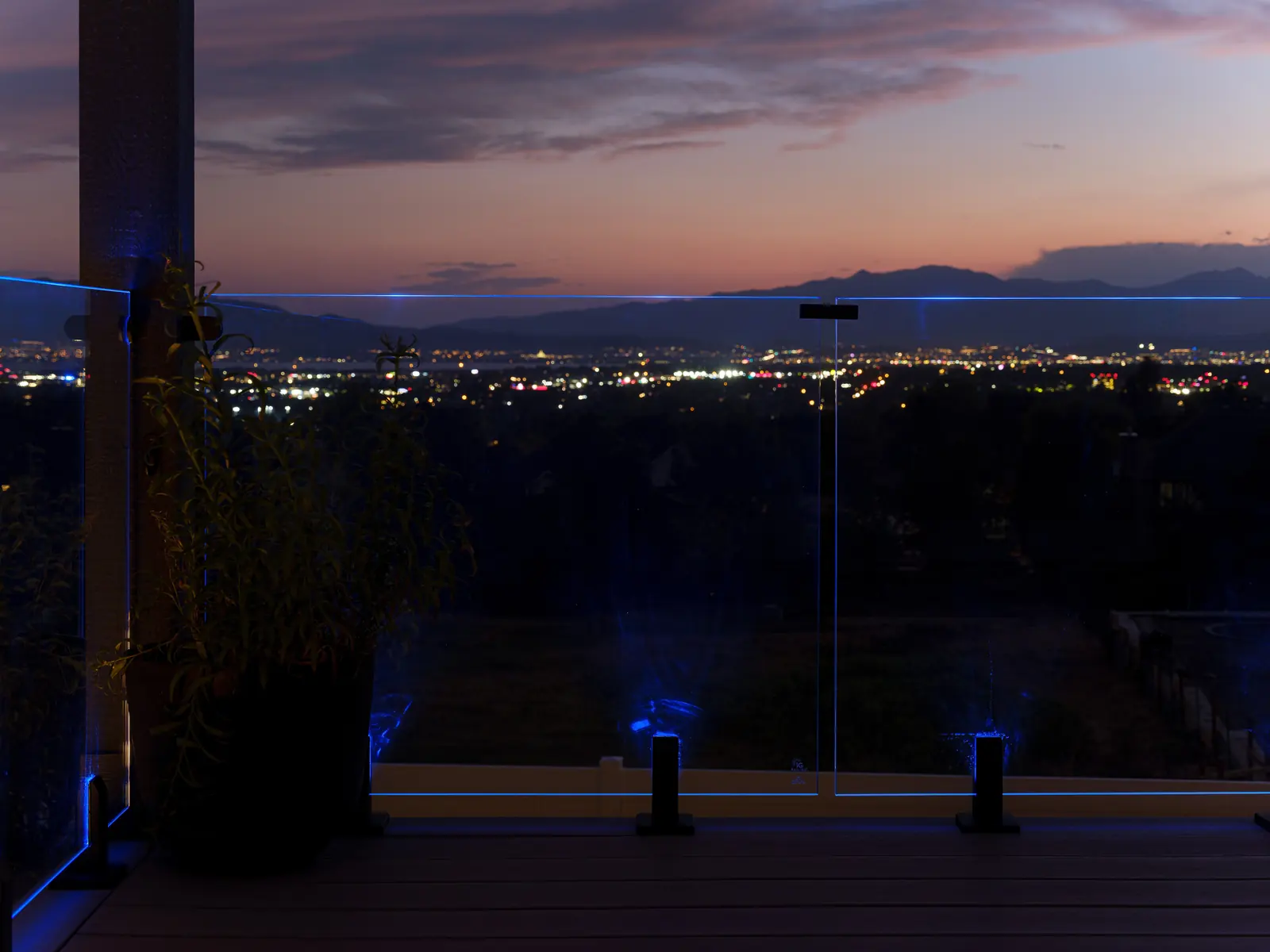 Illuminated IG glass railing at dusk overlooking the lights of Utah Valley from the Pleasant Grove foothills