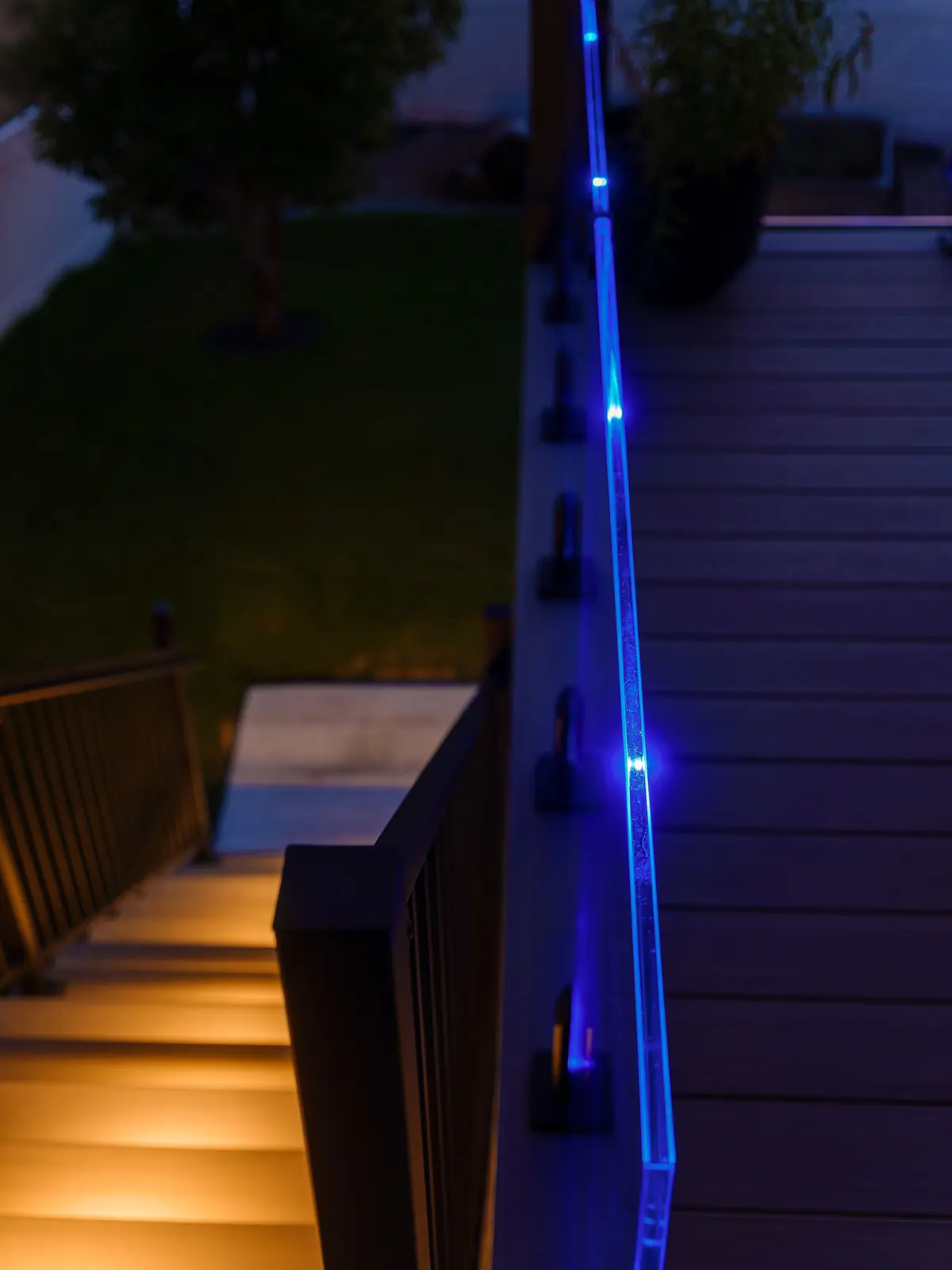 IG illuminated glass railing glowing blue along the top edge at night