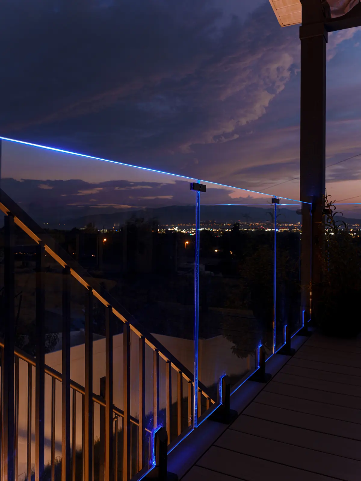 Glowing glass railing and black stair railing at sunset