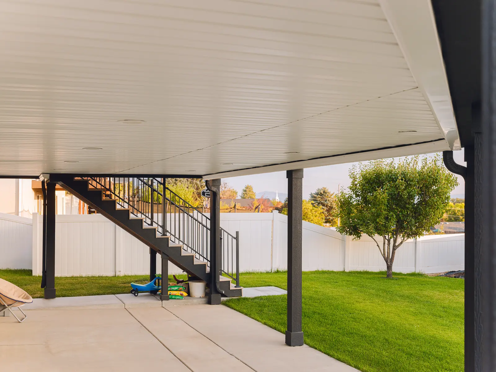Patio under the deck with stairs and a mountain view