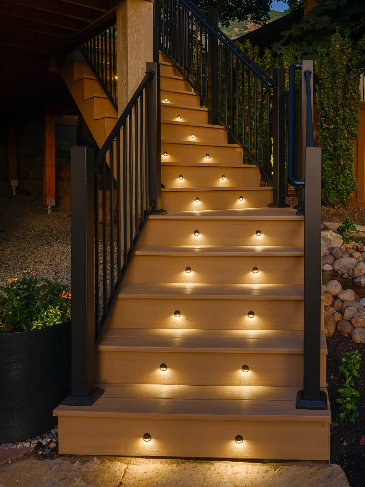 Composite deck stairs with riser lights and black aluminum railing
