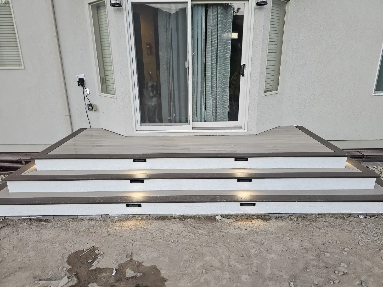 Two-tone TimberTech deck with step lights in Saratoga Springs