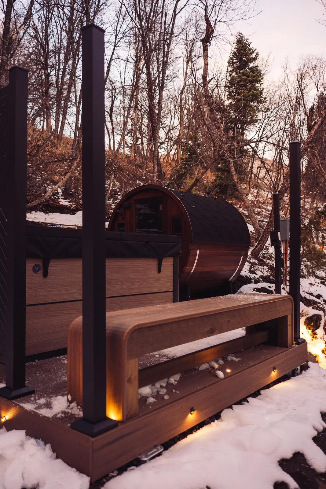 English Walnut sauna deck with a built-in bench and black posts