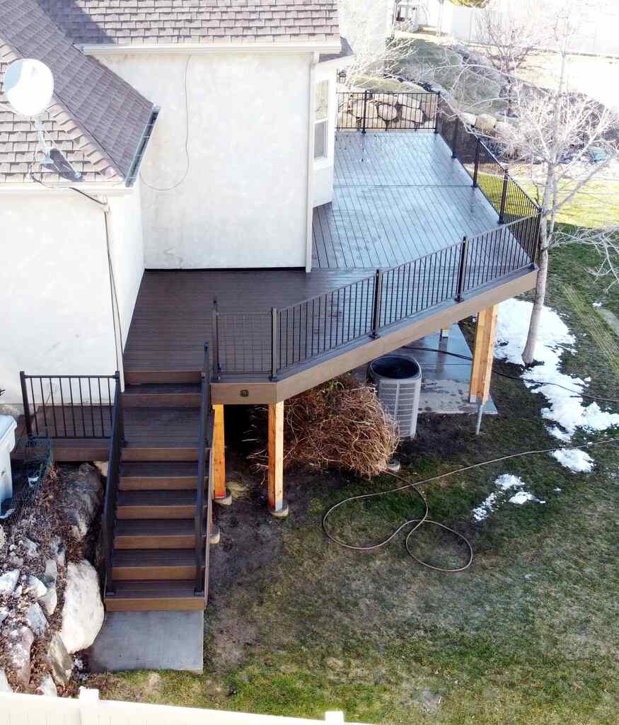 Comfort and style blend on patios with ledges for pets designed by TC Decks.